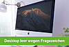 Ein PC-Monitor mit einem Hintergrundbild und leerem Desktop
