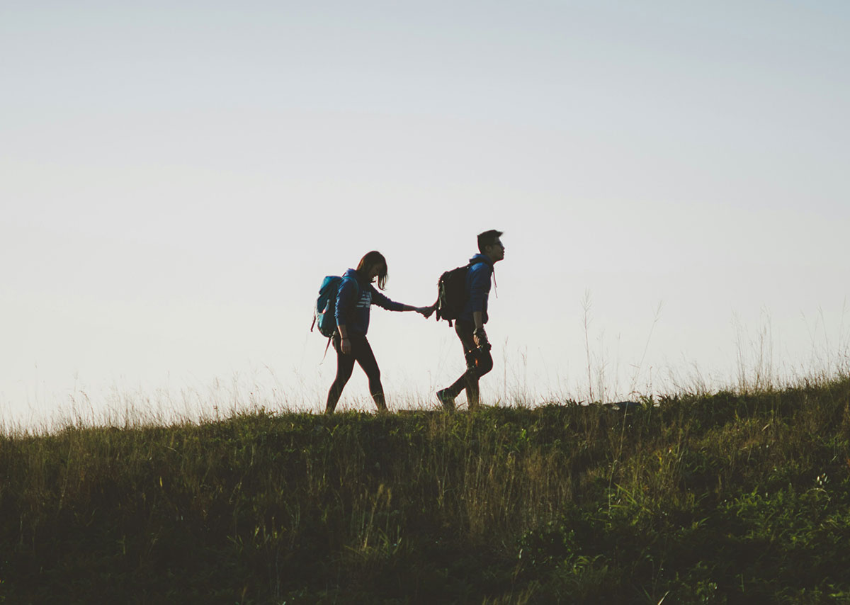 Was ist Offpage SEO? Das Bild zeigt die Silhouetten eines Paares, das auf einer Wiese wandert.